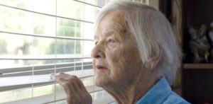 elderly woman looking out a window