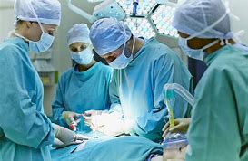 four medical doctors performing surgery