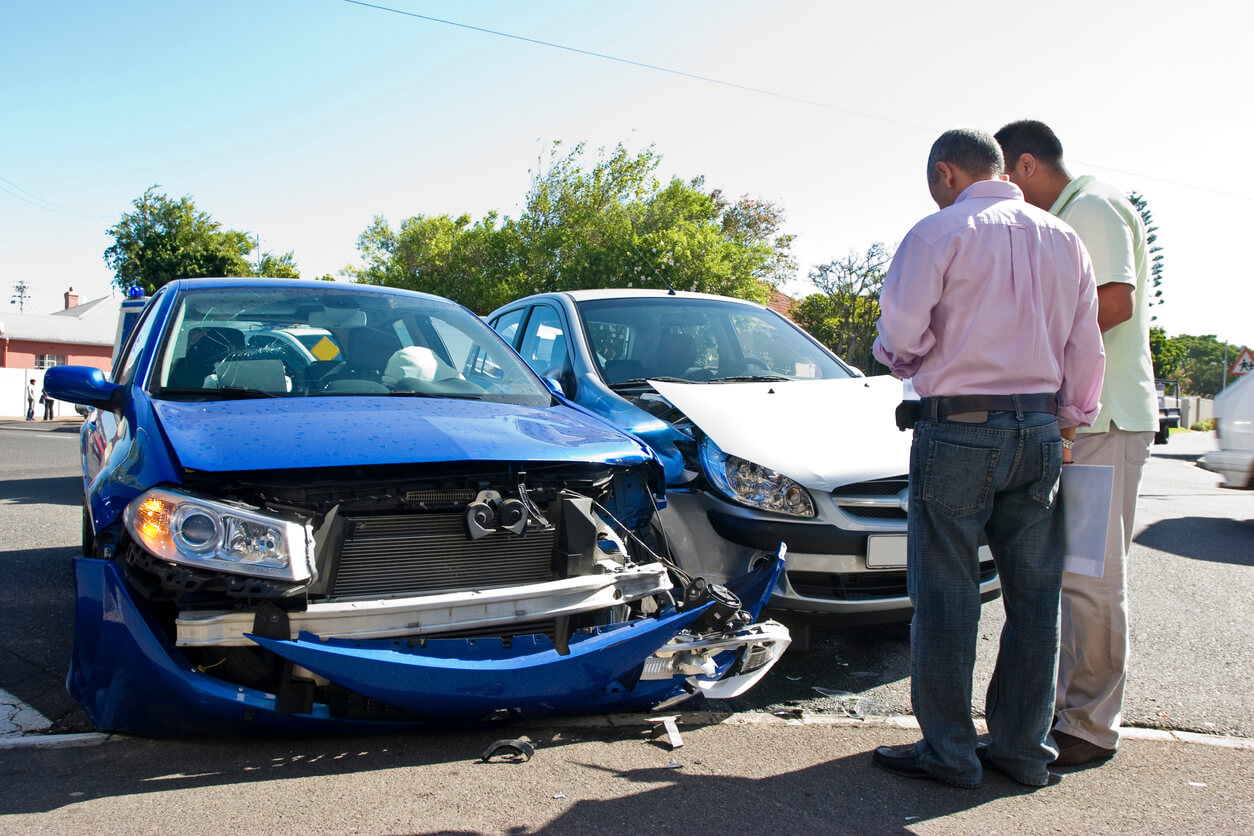 Two drivers surveying a car accident