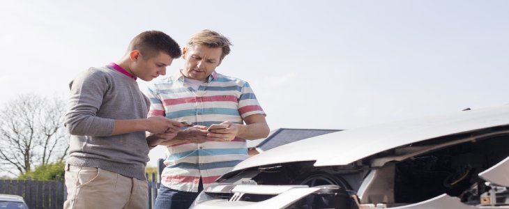 Two men exchanging insurances after accident