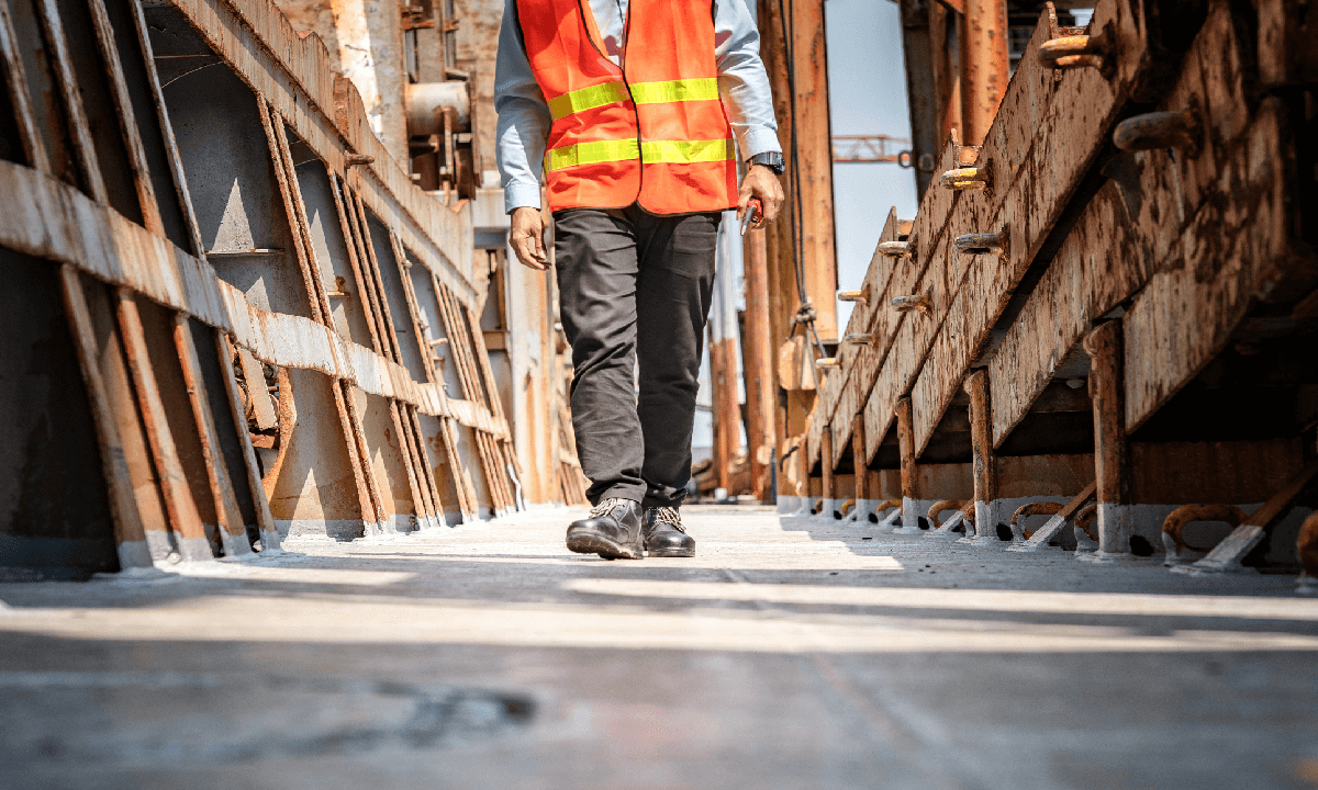 Construction worker walking on site.
