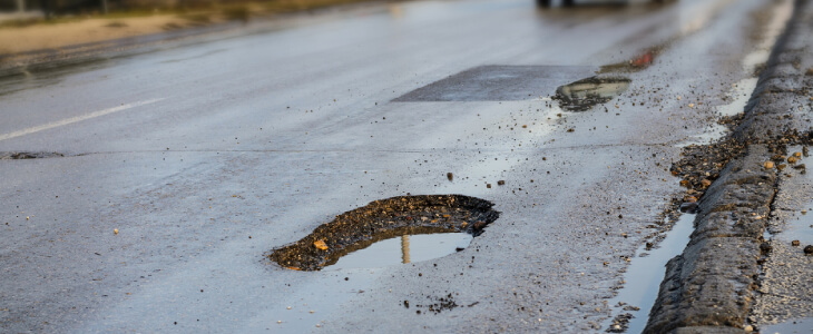 Damaged road with potholes