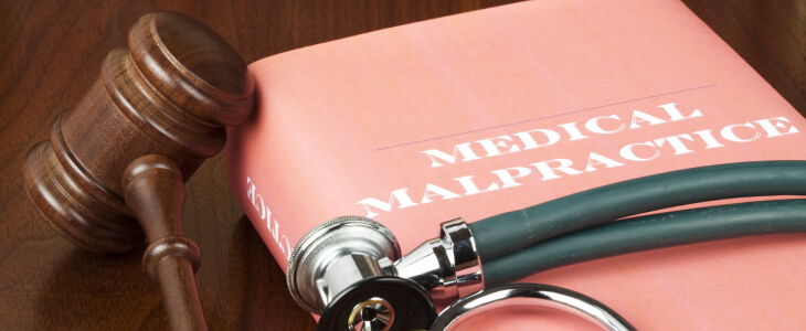 Gavel and red medical malpractice law book