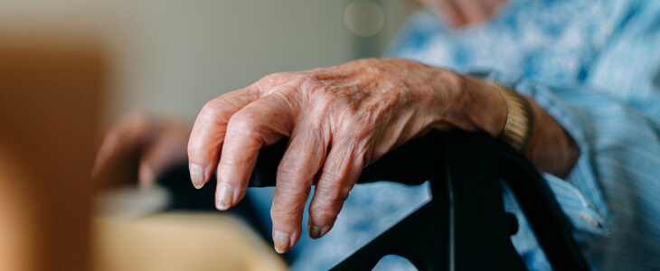 Close up of elderly woman's hand on a walker